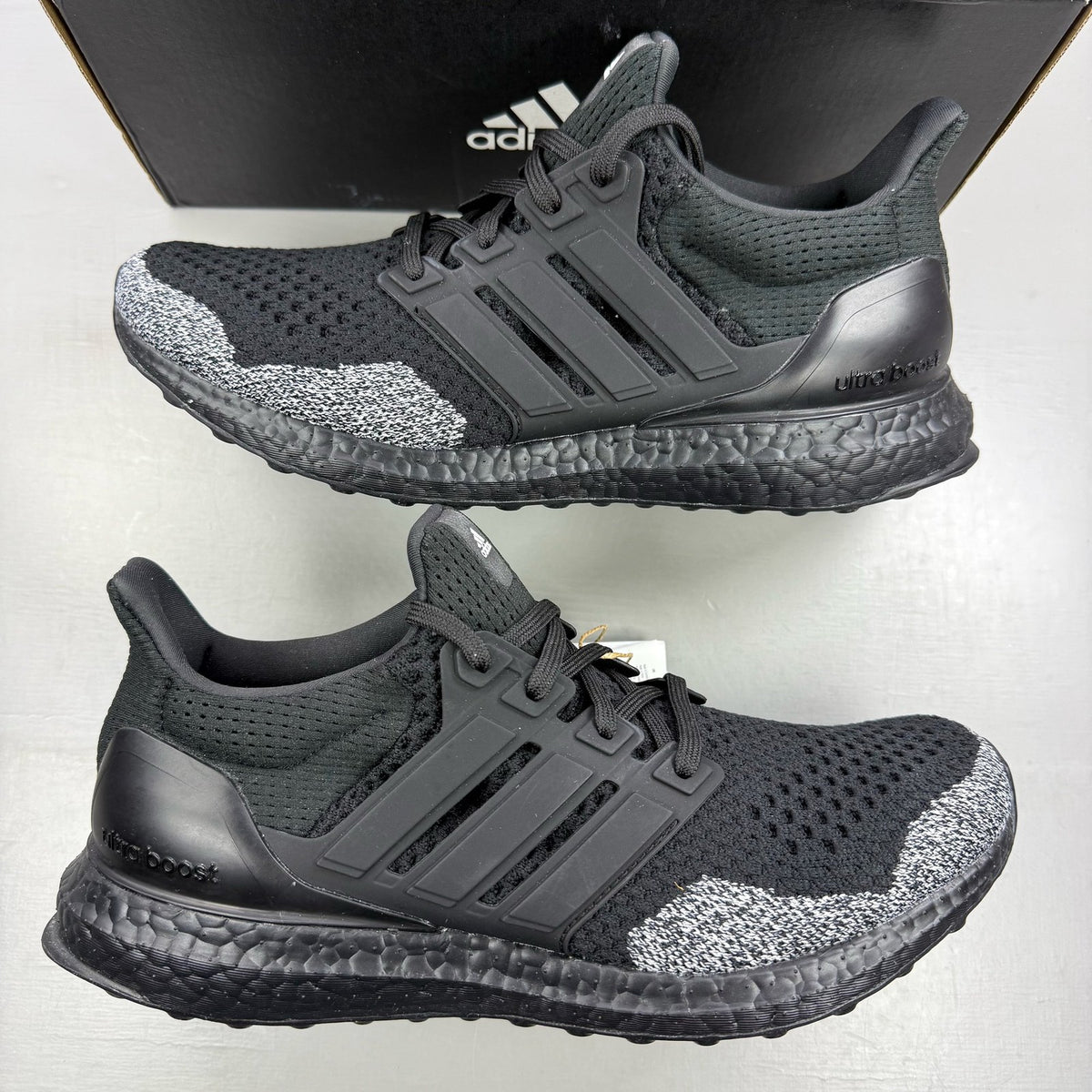 Adidas black Ultra Boost 1.0 trainers with core black and oreo toe design.