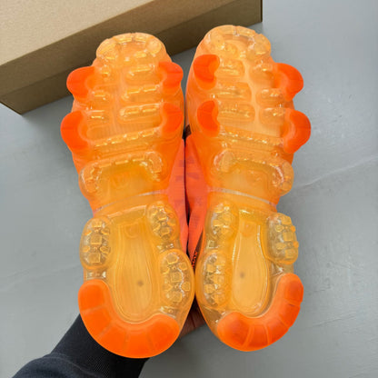 Nike grey trainers with total orange accents and Air VaporMax cushioning.