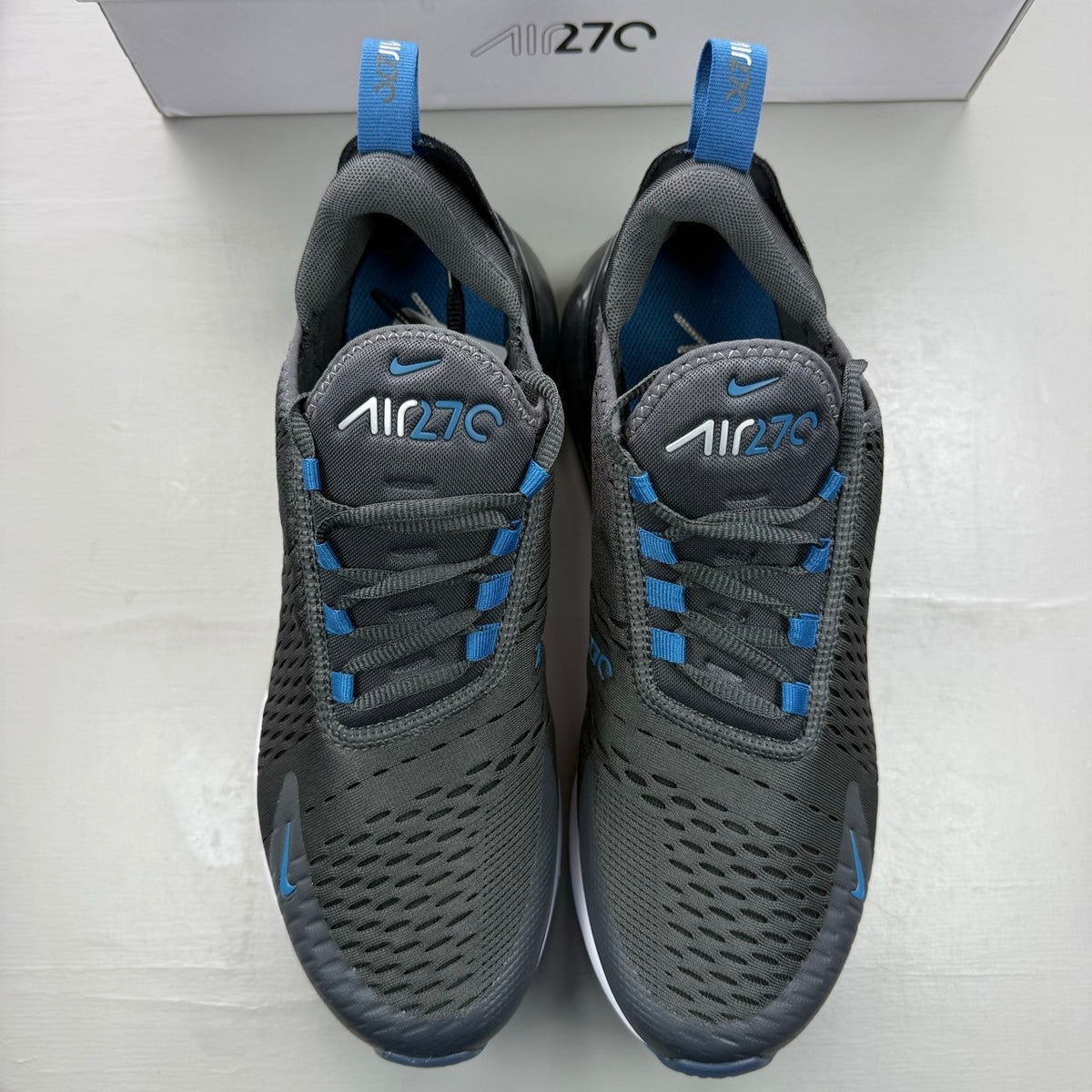Nike Air Max 270 grey sneakers with anthracite and industrial blue accents.