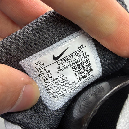 Nike Air Max 1 black trainers with silver and white accents, featuring iconic logo.