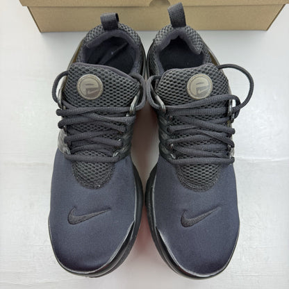 Nike Air Presto black trainers with logo detailing and breathable mesh upper.