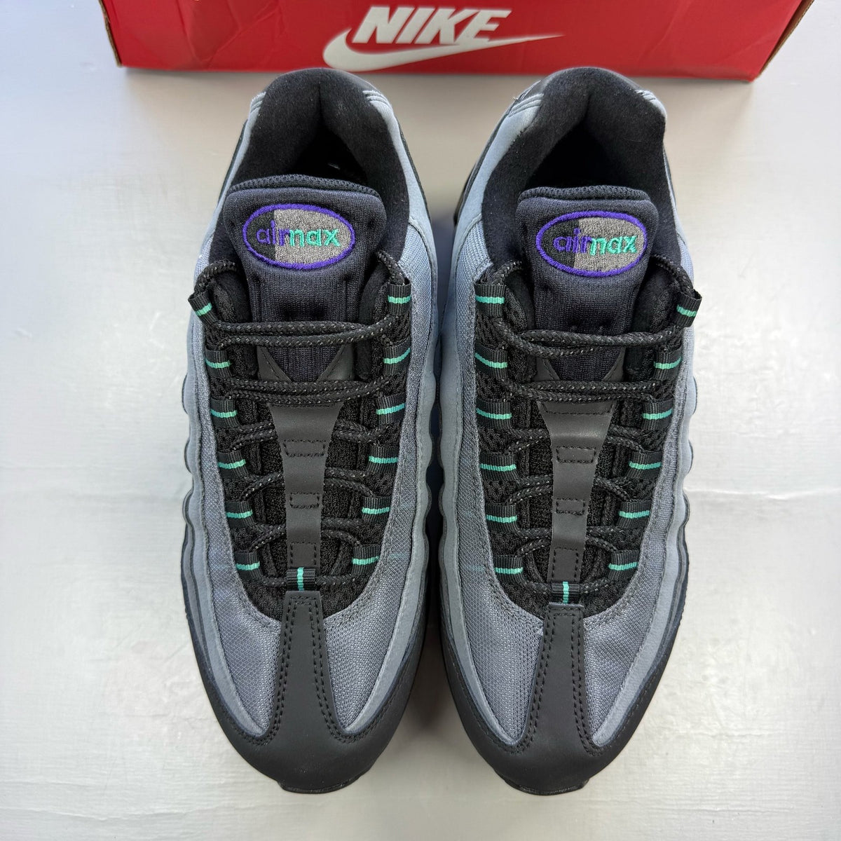 Nike Air Max 95 black trainers with big bubble design and multi-coloured accents.