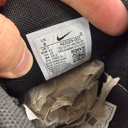 Nike Air Max Plus TN black leather trainers with distinctive wave pattern and logo.