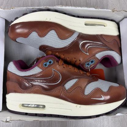 Nike Air Max 1 brown trainers with unique Patta logo and premium suede material.