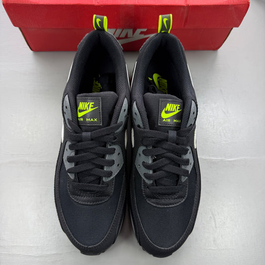 Nike black trainers with neon volt accents and white-grey detailing.