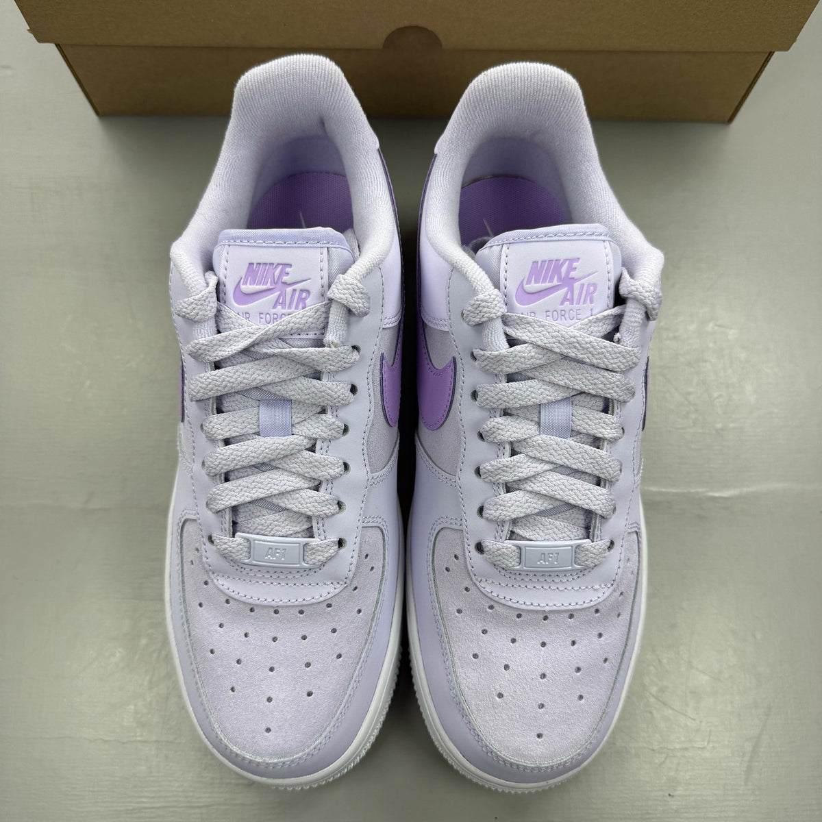 Nike Air Force 1 '07 purple trainers with classic white sole and logo detail.