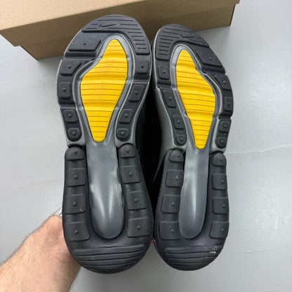 Nike black Air Max 270 trainers with grey and university gold accents, logo on tongue.