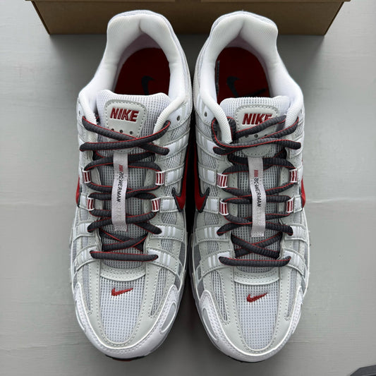 Nike P-6000 white trainers with grey and red accents, featuring a sleek design.