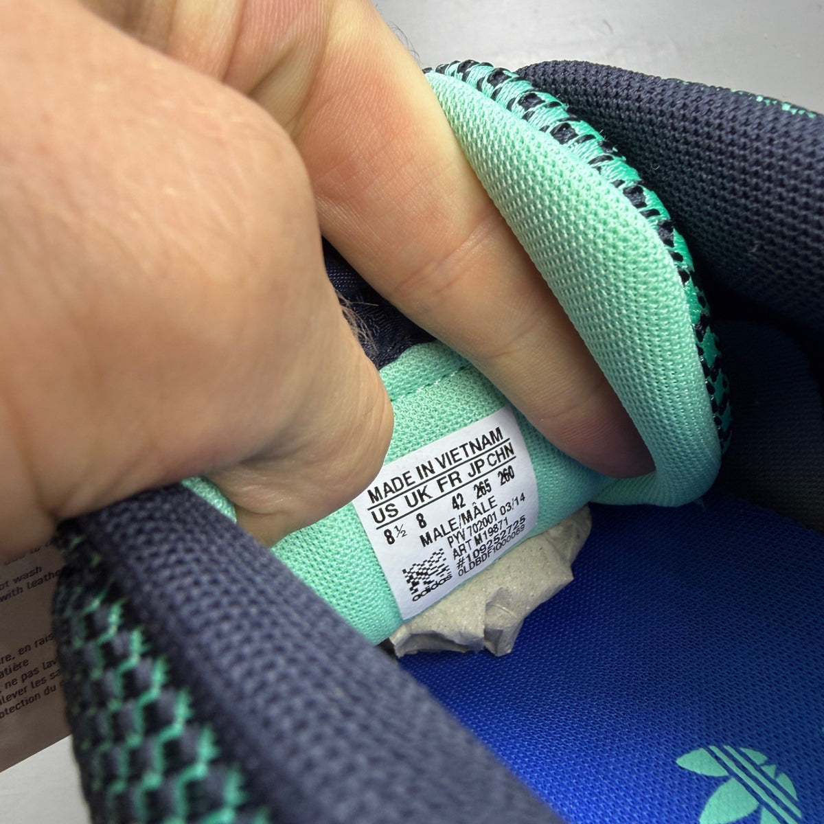 Adidas ZX Flux green trainers with woven texture and night navy accents.
