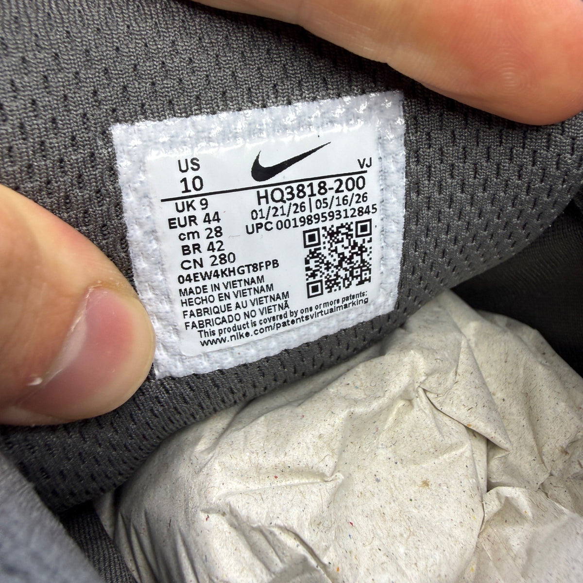 Nike P-6000 grey trainers with pink and black accents, mesh upper and logo detail.