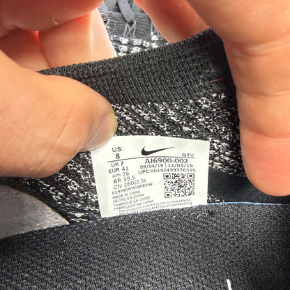 Nike athletic shoes black Flyknit design with white accents and VaporMax sole.