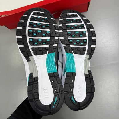 Nike white athletic shoes with dusty cactus accents and mesh upper details.