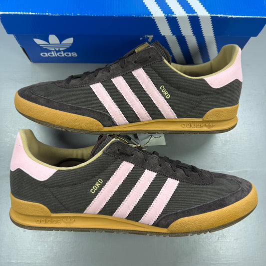 Adidas brown athletic shoes with pink accents and logo detail.