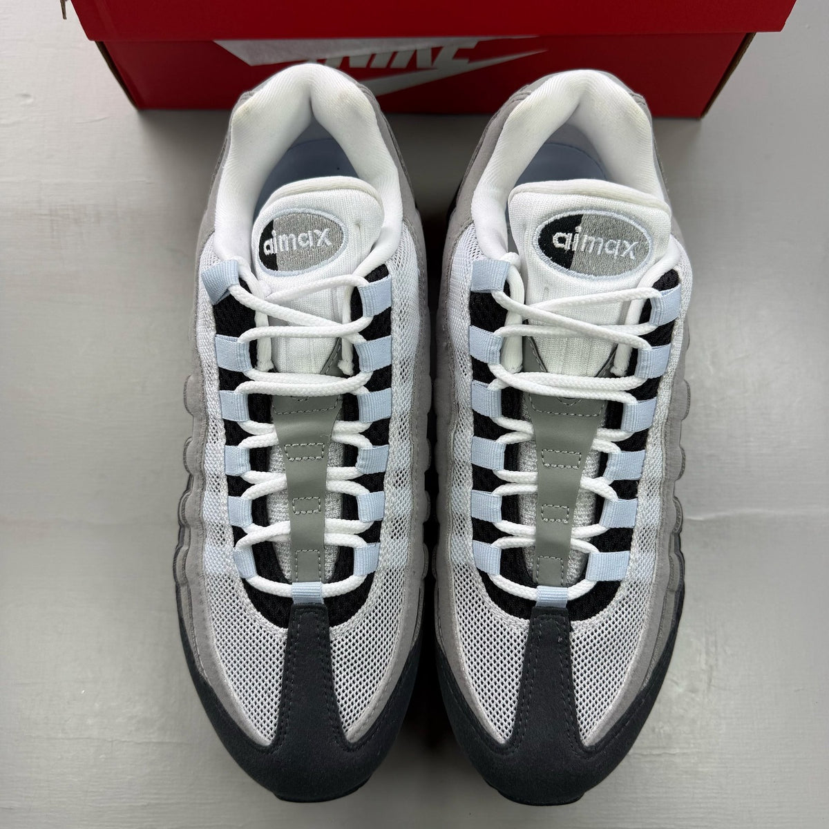 Nike Air Max 95 black trainers with big bubble design and reflective accents.