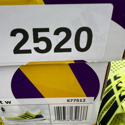 Adidas UltraBoost 1.0 yellow trainers with black and white accents, mesh upper.