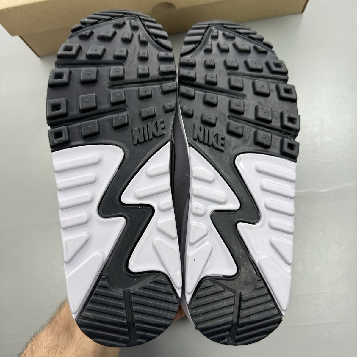 Nike Air Max 90 Futura black trainers with grey and white accents, sleek design.