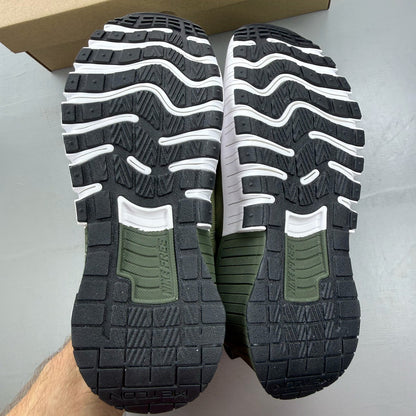 Nike green trainers with breathable mesh upper and cushioned sole.