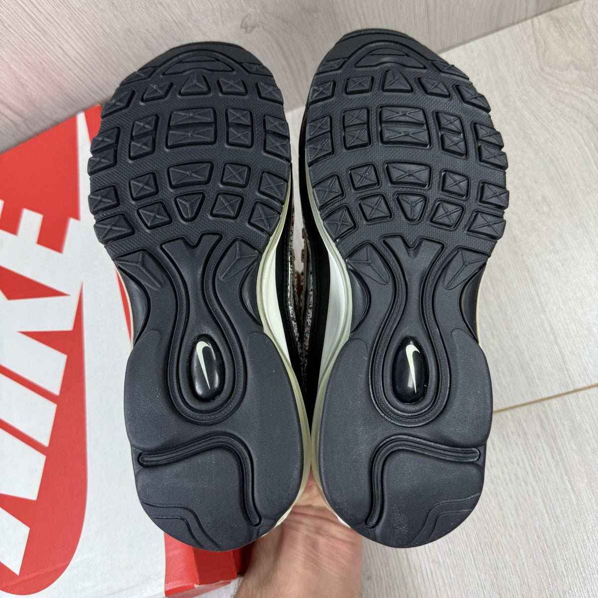 Nike Air Max 98 trainers black with white accents and signature logo detail.