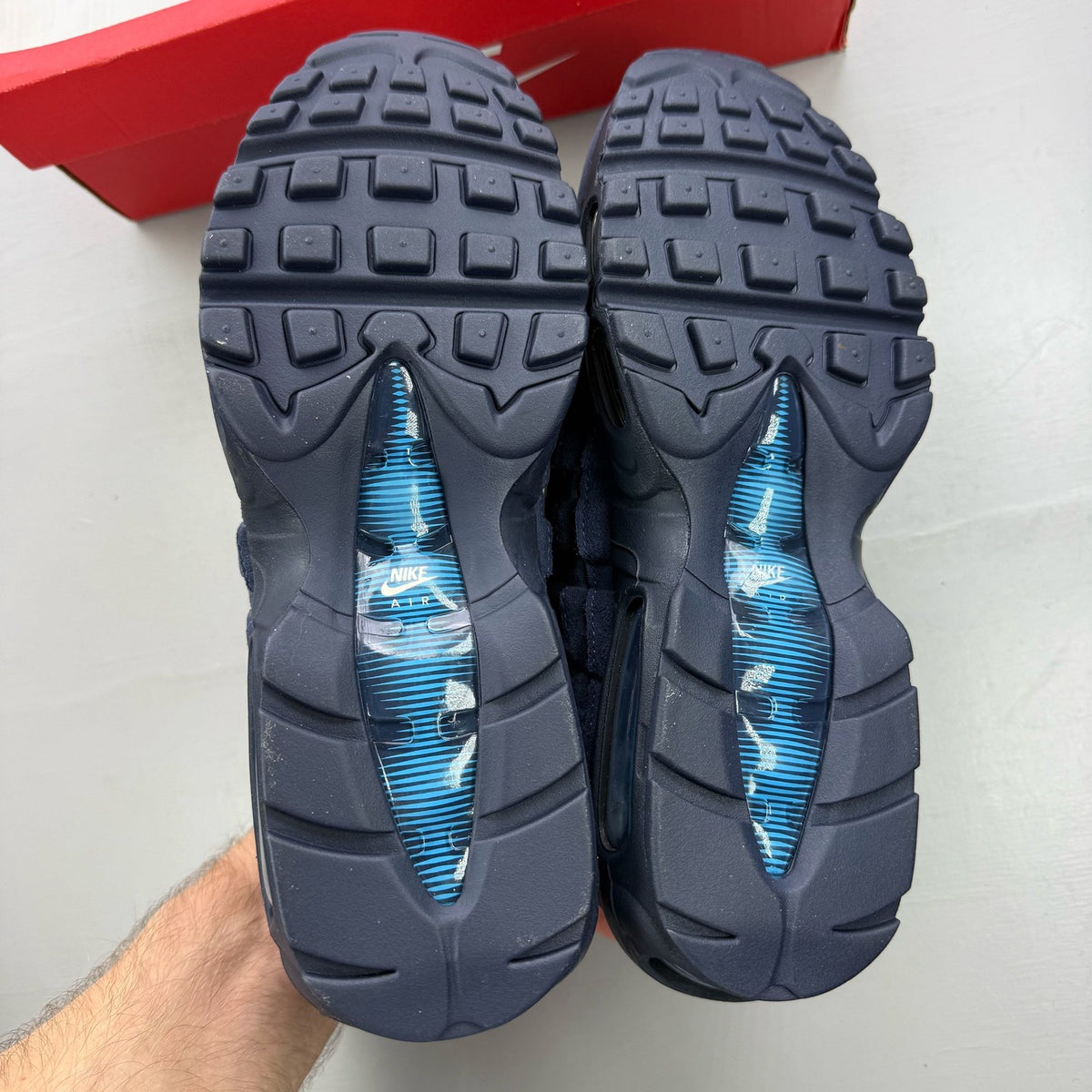 Nike Air Max 95 blue trainers with mesh upper and signature swoosh logo.