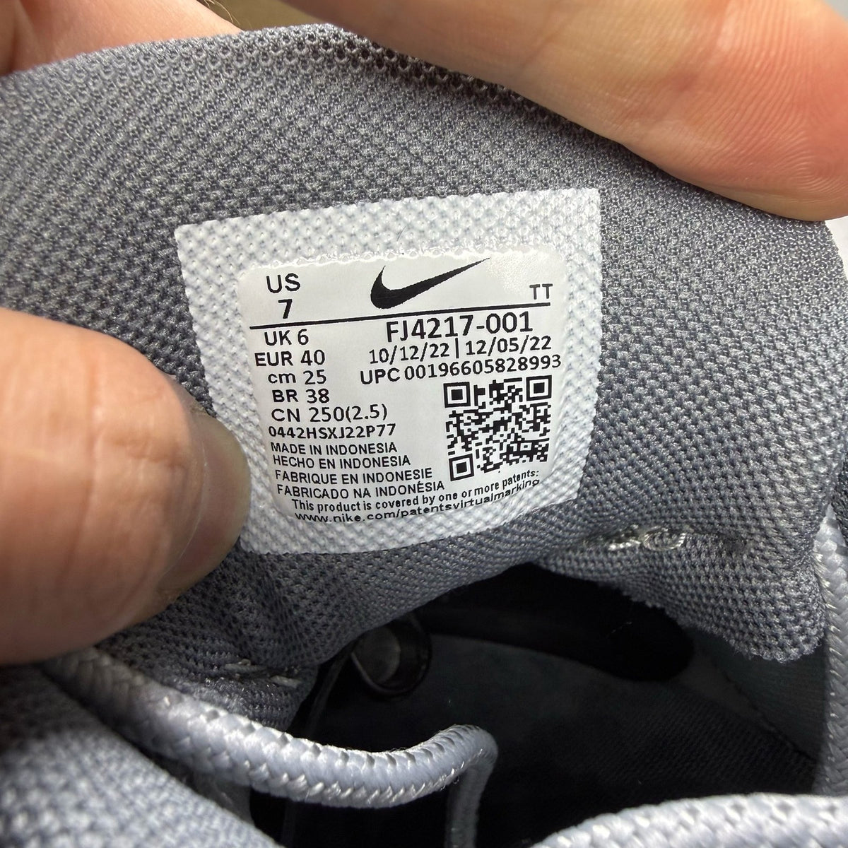Nike Air Max 95 grey trainers with white accents and signature logo details.