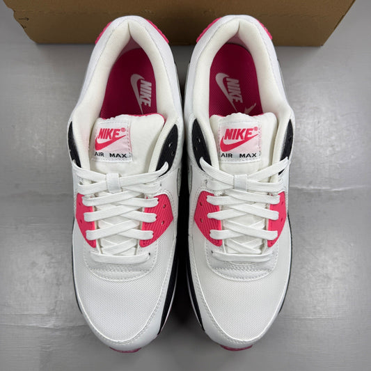 Nike Air Max 90 white trainers with aster pink and black accents, logo on tongue.