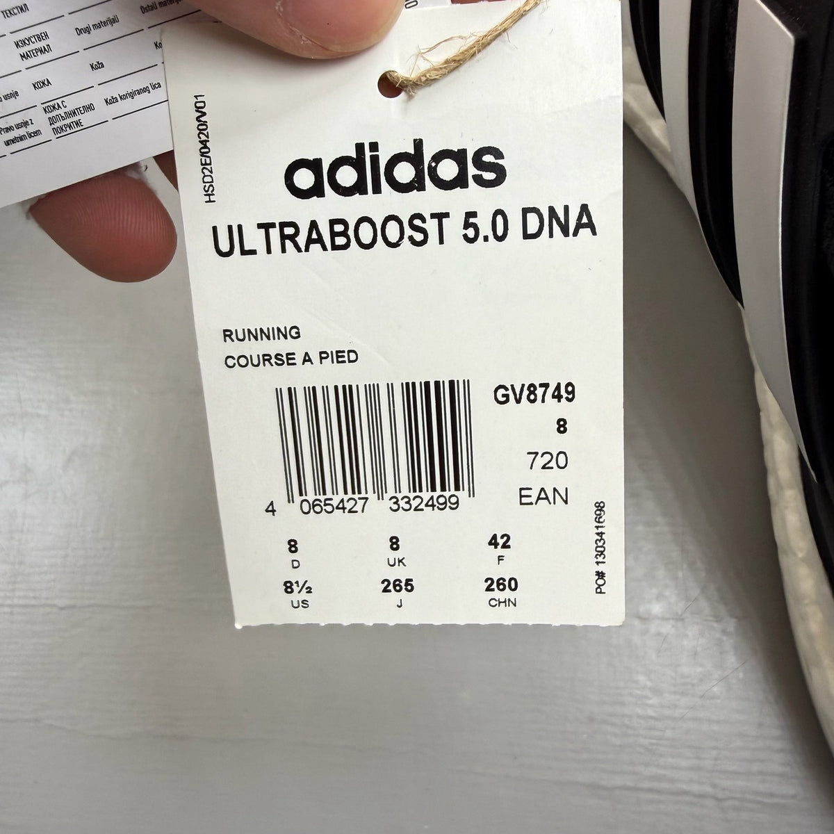 Adidas black Ultra Boost 5.0 trainers with white accents and logo detailing.