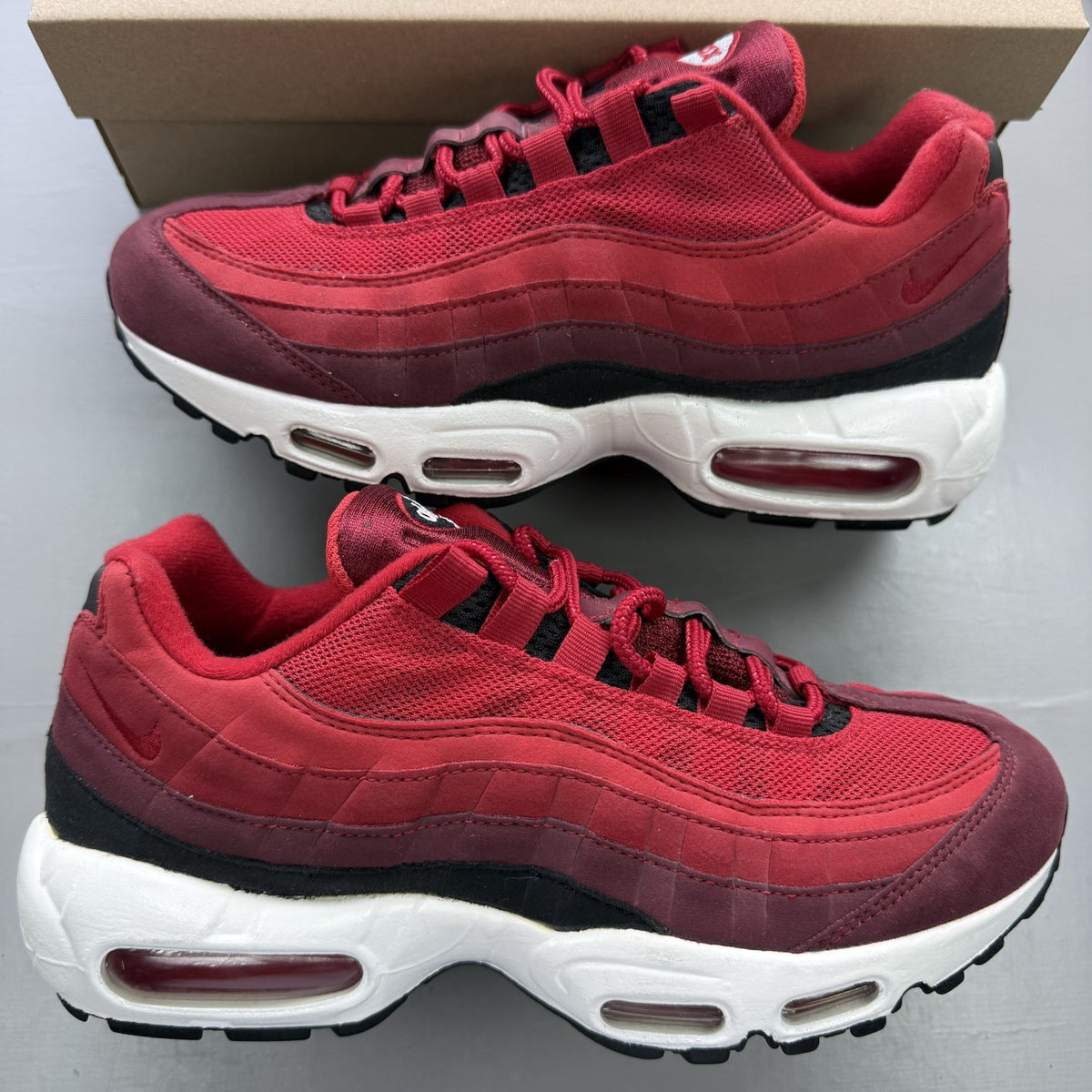 Nike Air Max 95 red maroon black white trainers with signature logo and mesh detailing.