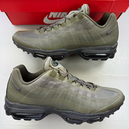 Nike Air Max 95 Ultra green trainers with black accents and logo details.