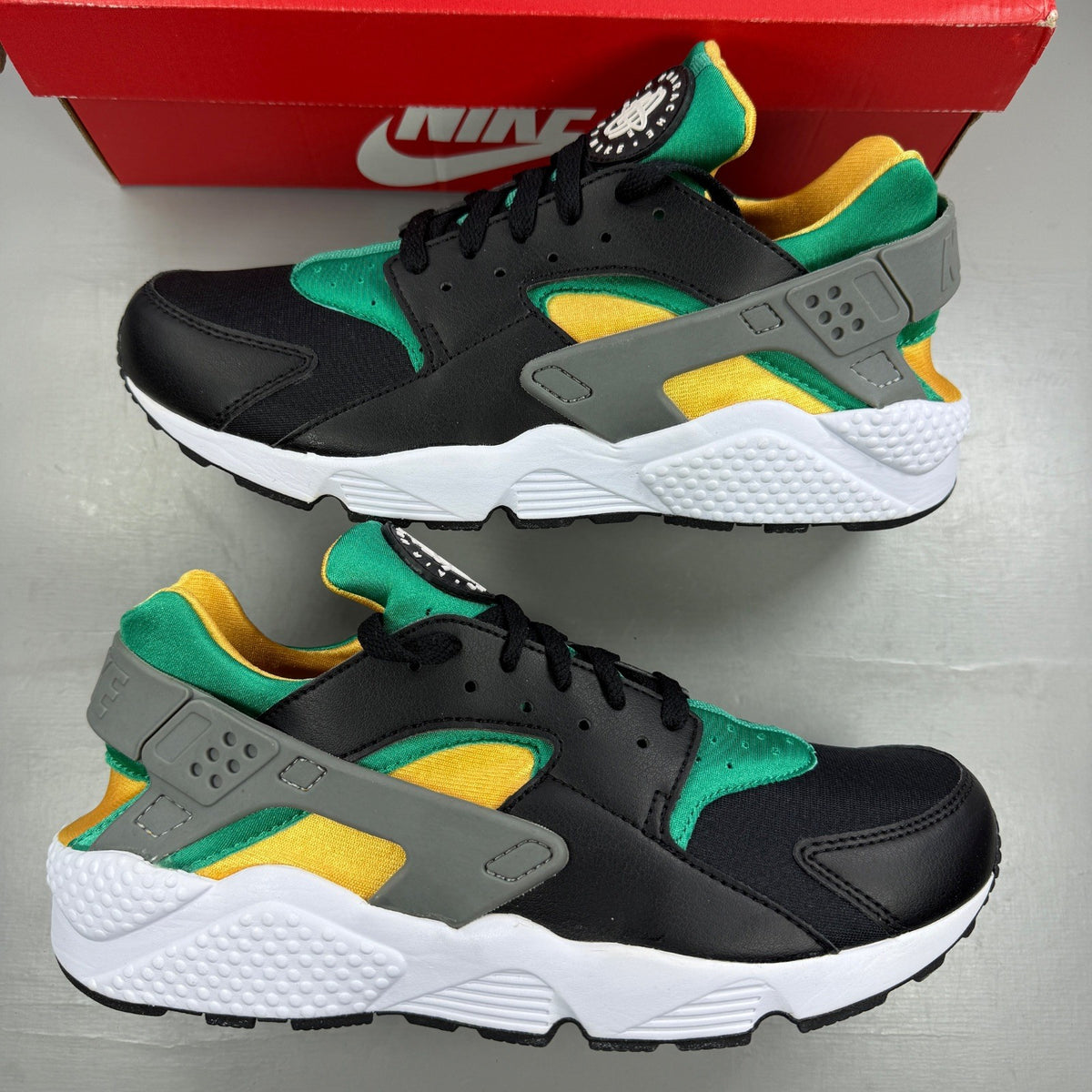 Nike athletic shoes black with emerald green accents and white sole, featuring iconic logo.