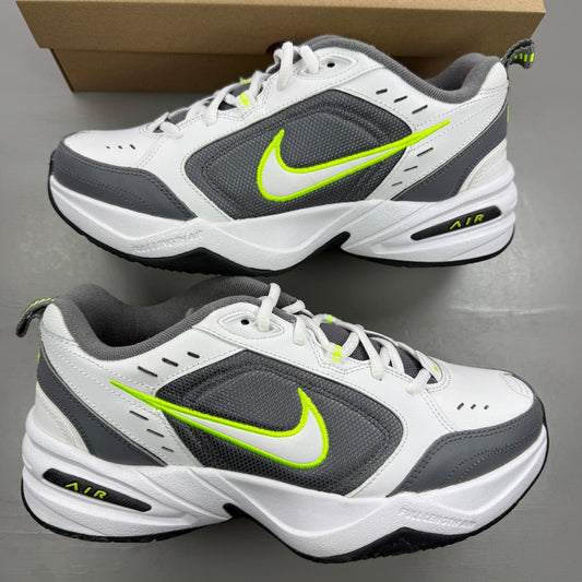 Nike Air Monarch IV white trainers with cool grey and green accents, featuring logo detail.