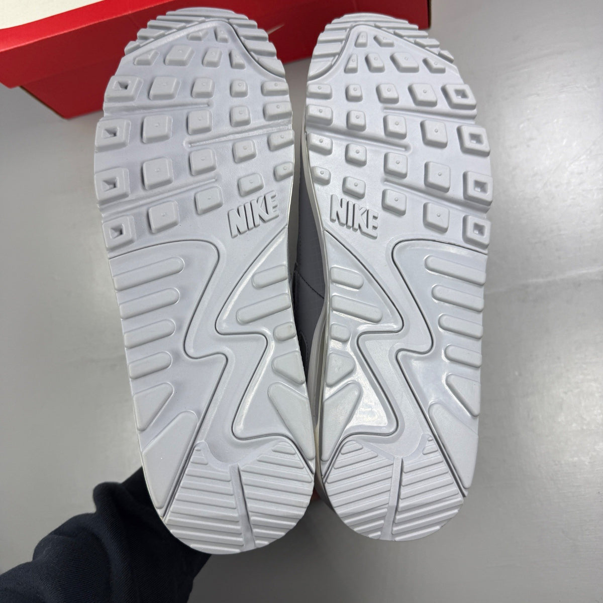 Nike running shoes grey mesh upper with white accents and signature swoosh logo.