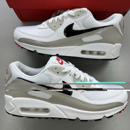 Nike Air Max 90 white trainers with black and red accents, featuring iconic logo and design.