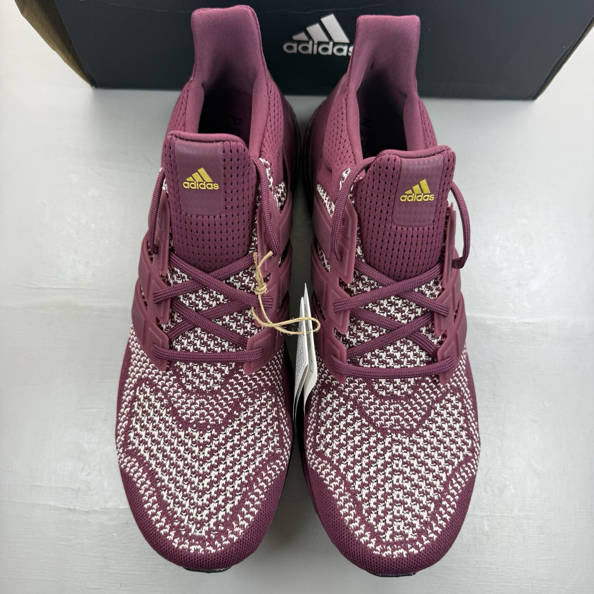 Adidas UltraBoost 1.0 DNA red trainers with signature three stripes and knit upper.