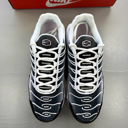 Nike trainers white with pink accents and black detailing, featuring Air Max cushioning.