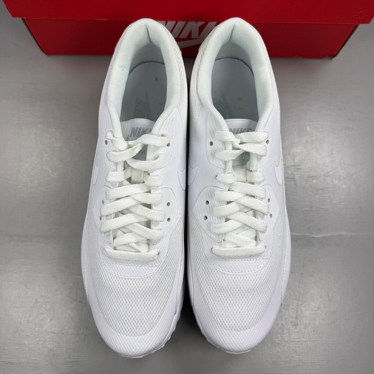 Nike trainers white mesh upper with signature swoosh logo and cushioned sole.