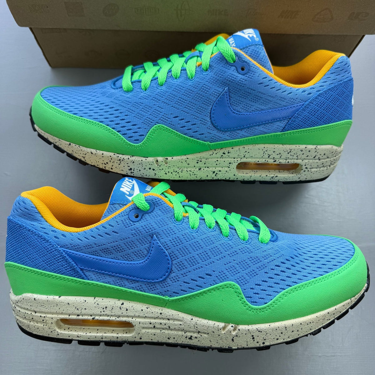 Nike Air Max 1 EM blue trainers with mesh upper and signature swoosh logo.