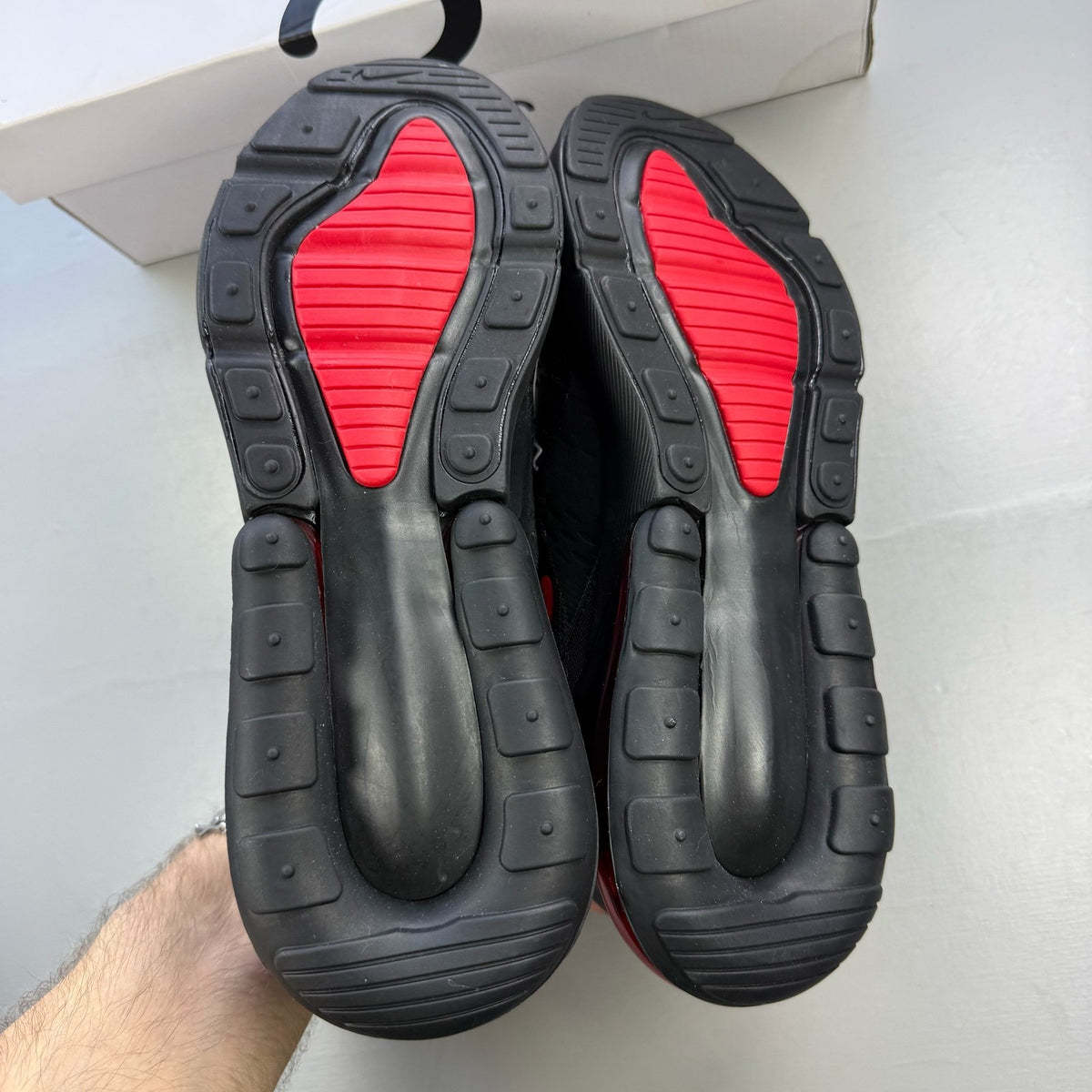 Nike Air Max 270 black trainers with university red accents and white sole.
