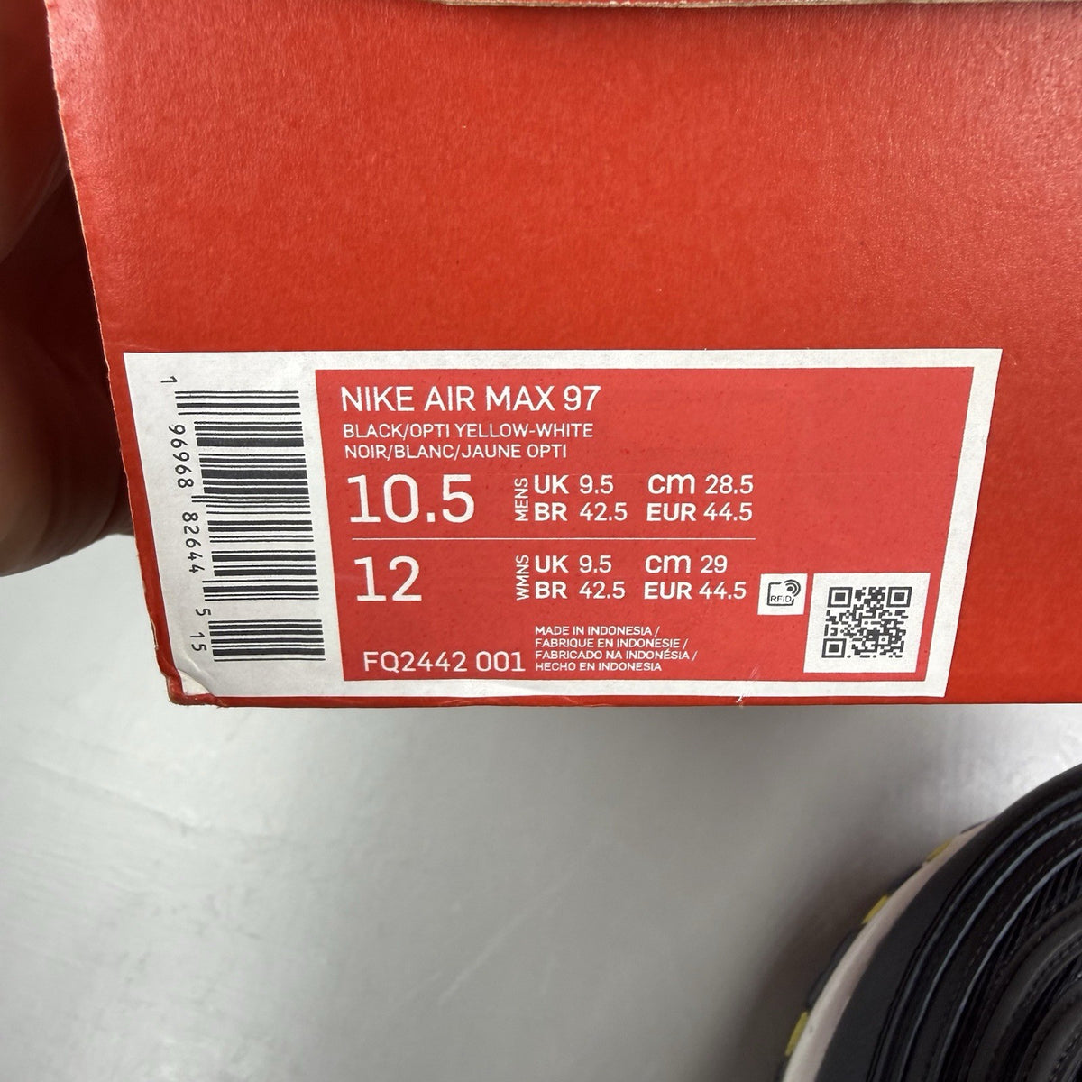 Nike Air Max 97 black trainers with opti yellow accents and white sole.