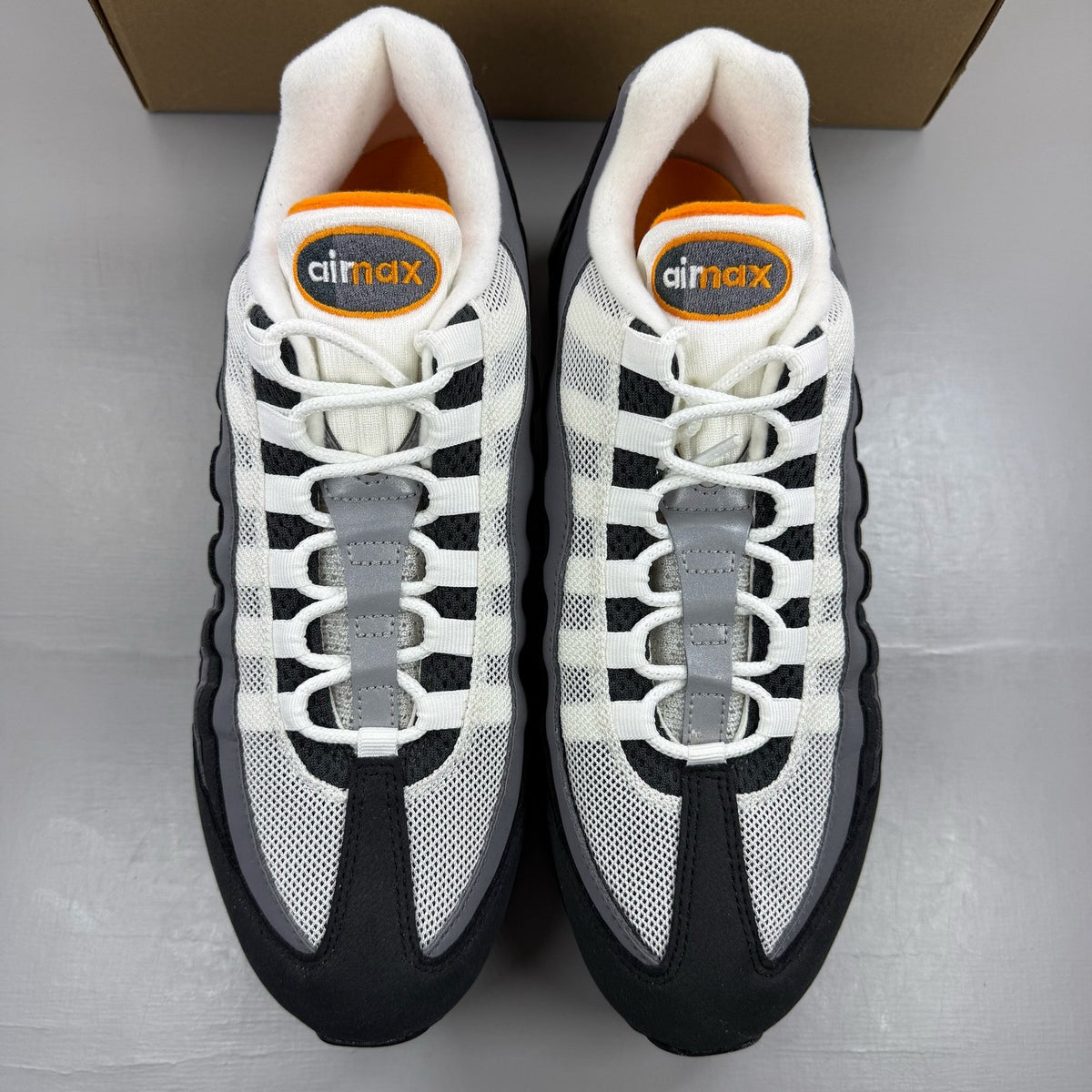 Nike Air Max 95 grey trainers with big bubble design and signature swoosh logo.