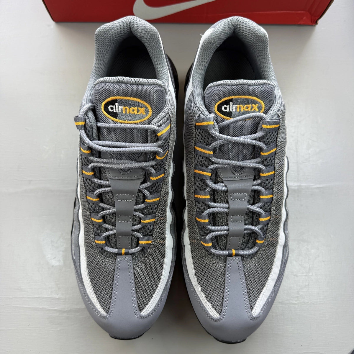 Nike Air Max 95 grey trainers with sundial accents and signature logo details.