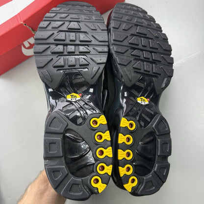 Nike black trainers featuring wood camo pattern and Air Max Plus design.