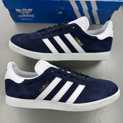 Adidas blue suede trainers with white stripes and logo detail.