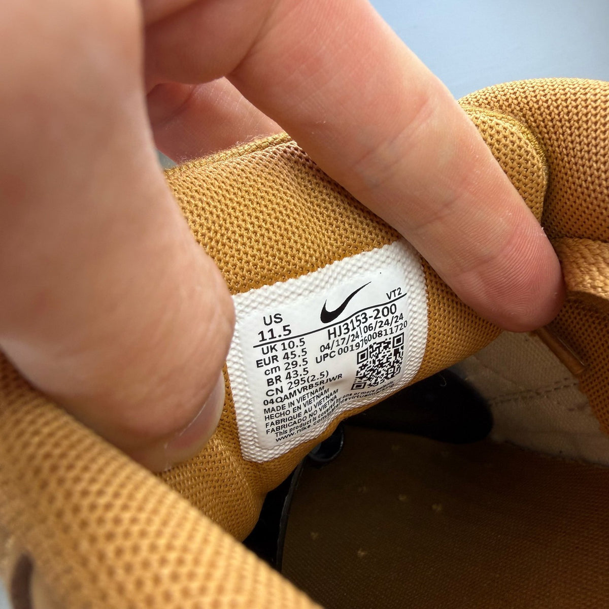 Nike Air Max 90 brown trainers with premium suede material and iconic swoosh logo.