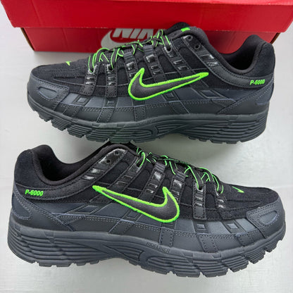Nike P-6000 black trainers with green accents and mesh panels, 100% authentic.