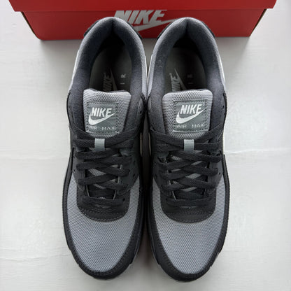 Nike Air Max 90 black trainers with smoke grey accents and logo detail.