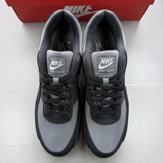 Nike Air Max 90 black trainers with smoke grey accents and logo detail.