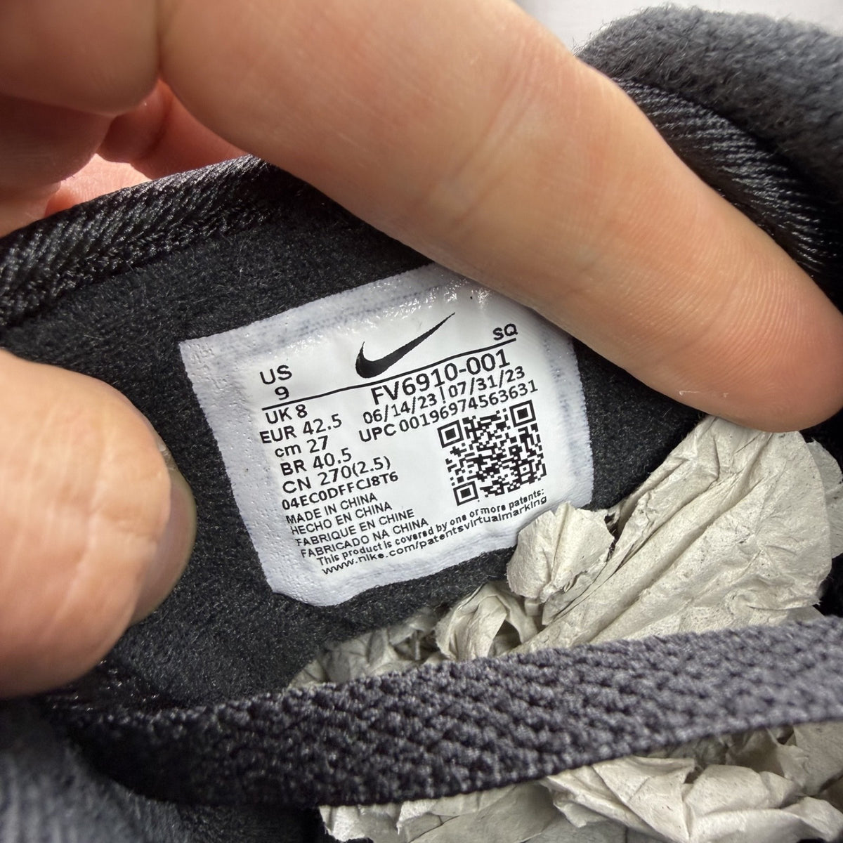 Nike Air Max 1 black trainers with university red accents and logo detail.
