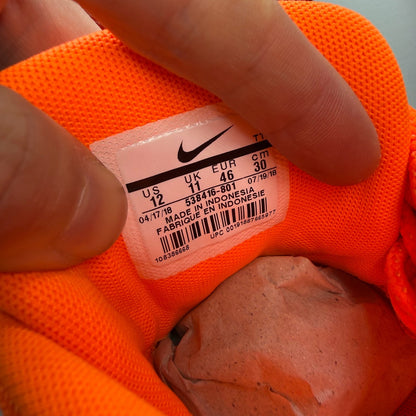 Nike Air Max 95 orange trainers with white overbranding and logo details.