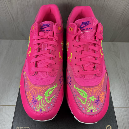 Nike Air Max 1 PRM trainers pink with Día De Muertos pattern and white accents.