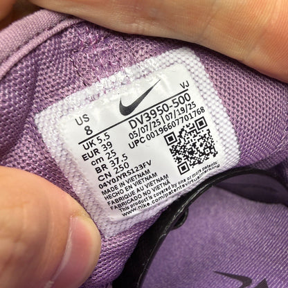 Nike Free Metcon 5 purple trainers with mesh upper and logo detail.